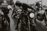 Group of motorcyclists riding on a wet street showcasing dynamic and adventurous vibe.